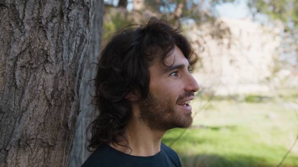 istock Young Long Hair Man Marveled In Nature Near A Tree 2194392140