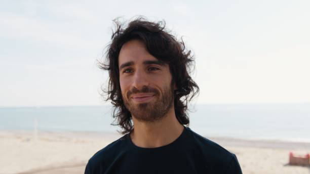 istock Man Makes A Slight Smile Of Approval Thinking About His Success On The Beach 2194392234