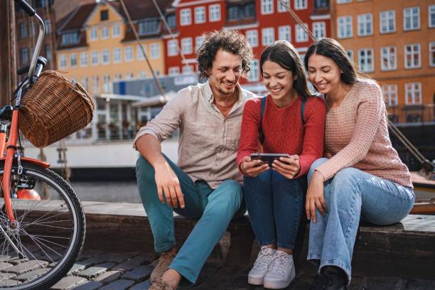 istock Tourists using a smartphone in nyhavn, copenhagen, denmark 2194392374