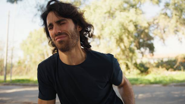 istock Young Man Sitting Tired Complains of Back Pain Sciatica After a Day at Work 2194392449