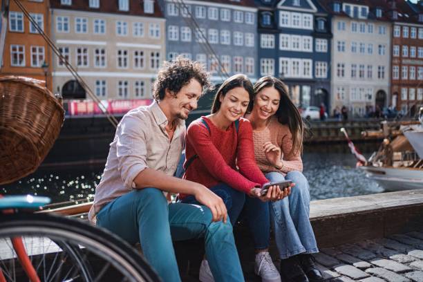 istock Tourists using smartphone in nyhavn, copenhagen, denmark 2194392490