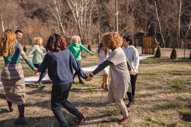 istock Group psychotherapy outdoors holding hands and running in a circle 2194393128