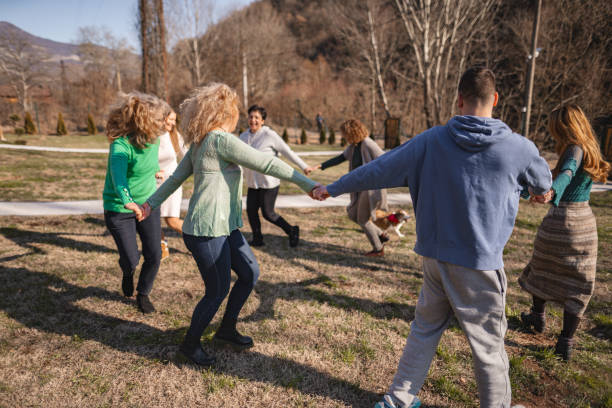 istock Group psychotherapy outdoors holding hands and running in a circle 2194393246