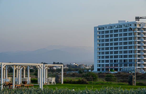 istock Modern building overlooking serene landscape at dusk with distant mountains in the background 2194395113