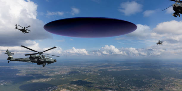 istock UAP/UFO Hovering In Sky Surrounded by Helicopters 2194395204