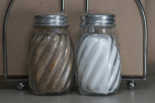 Solitary salt shaker on the table with blurred background