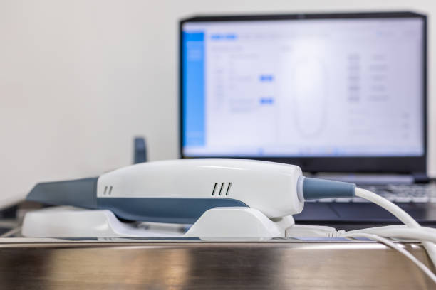 istock Intraoral scanner with connected software system in the background, used for creating accurate 3D dental impressions for restorative treatments 2194395754