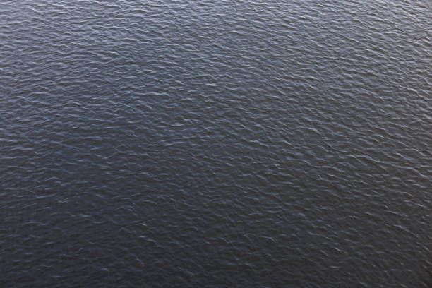 Dark blue water surface of vltava river flowing in prague