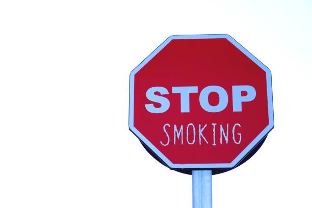 istock Stop smoking. public health problem. letters written on a highway stop sign. 2194397009