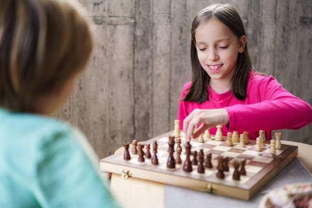 istock Girl playing chess game whit her friend 2194399102