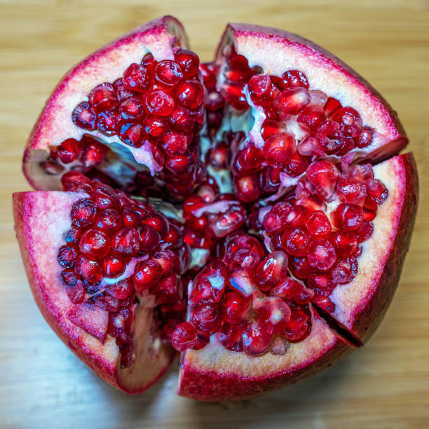 Top view of a fresh ripe pomegranate fruit cut into beautiful slices