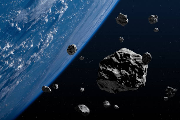 istock Big and small asteroids near planet Earth in space. 2194400603