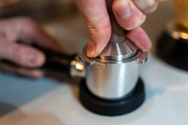 istock Coffee Preparation: Barista Tamping Espresso Grounds 2194401548