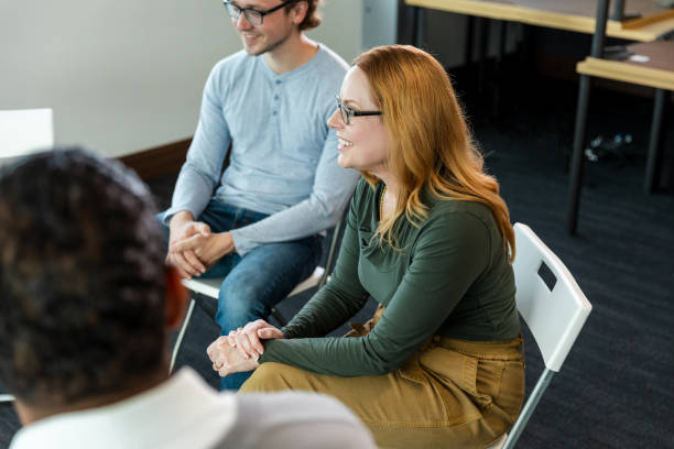 istock Group therapy session: diverse adults talking and listening 2194401557