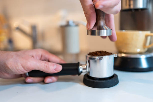 istock Barista Tamping Freshly Ground Coffee for Espresso 2194401643