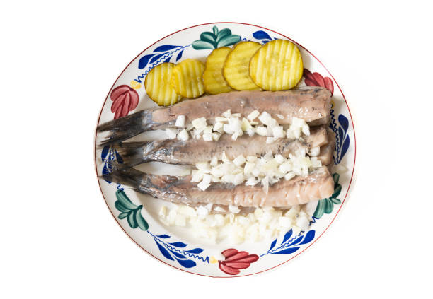 Raw whole salted herring fish served parsley
