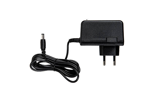 istock A black power adapter with a European plug and a coiled cable, designed for electronic devices, highlighting its practical and functional design. 2194403024