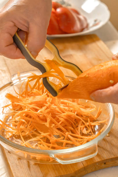 istock Chef grated carrots with a hand grater. Close-up 2194403219