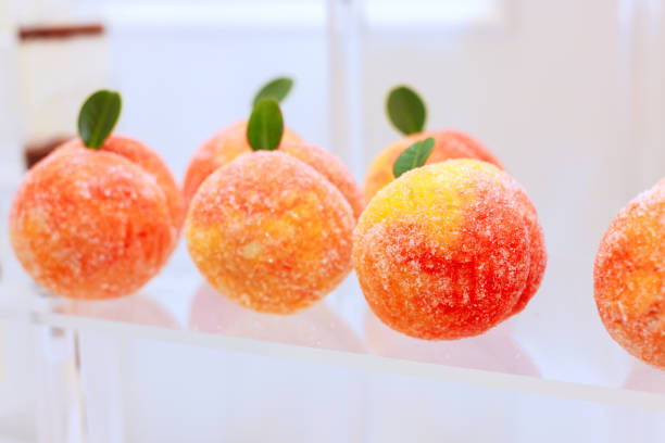 Peach shaped confections displayed elegantly at dessert event party