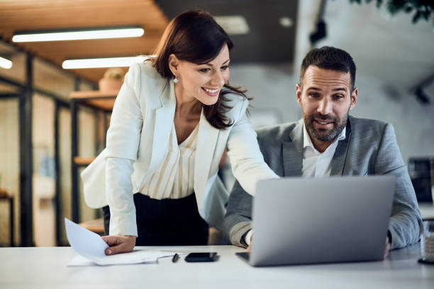 istock Two business partners working together at the office, using a laptop. 2194405065