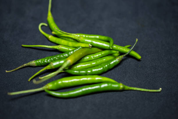 istock fresh green hot chilli Close-Up on black Background studio shot 2194406241