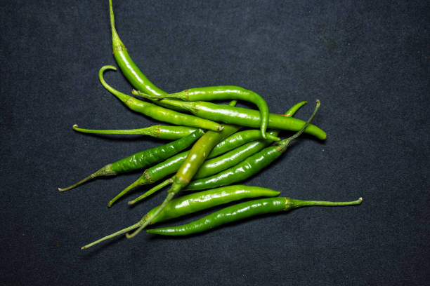 istock fresh green hot chilli Close-Up on black Background studio shot 2194406242