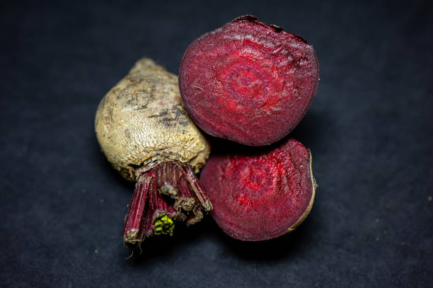 fresh raw beetroot slice close-up studio shot on black background