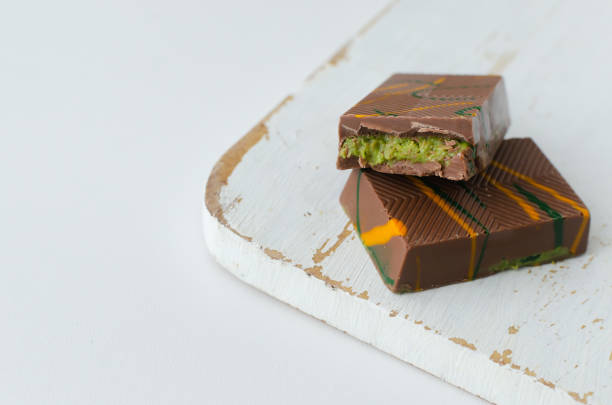 istock Dubai chocolate with pistachio paste and kunefe filled milk on the white cutting board . Popular food concept. 2194406848