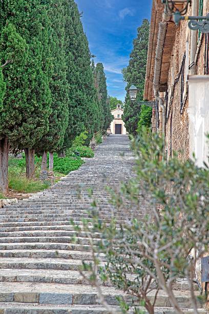 Escales El Calvari stairs surrounded by lush gardens in Pollenca