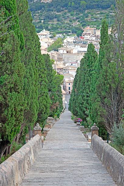 Escales El Calvari stairs surrounded by lush gardens in Pollenca