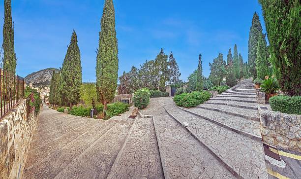Escales El Calvari stairs surrounded by lush gardens in Pollenca