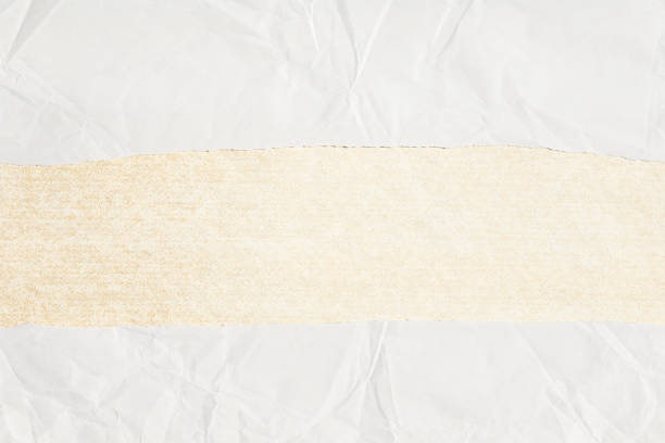 White crumpled paper with brown paper stripe in the middle
