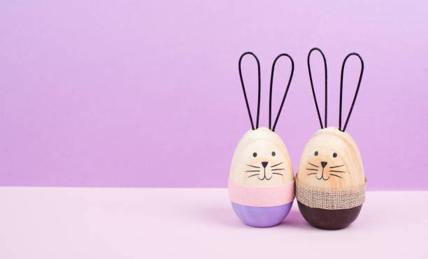 istock Easter bunny or rabbit couple cuddle together, wooden egg, spring holiday greeting card 2194413875