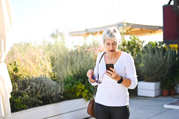 Mature woman reading a phone message.
