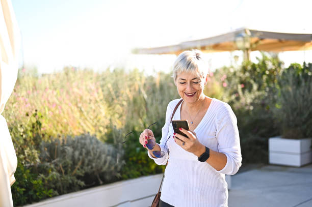 istock Mature woman after work with mobile phone. 2194415516
