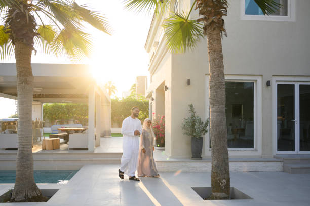 istock Emirati couple walking outside luxury private villa in sunlight 2194416105
