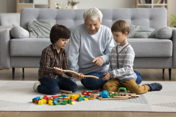 istock Great-grandfather spend time with cute little great-grandsons 2194421331