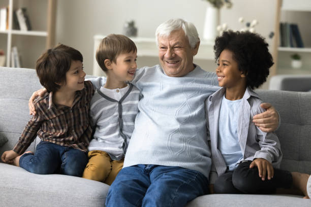 istock Three multiethnic brothers spend time with mature great-grandpa 2194422153