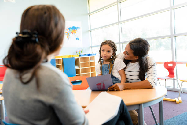 istock Teacher and mother discussing child's development in school 2194423038