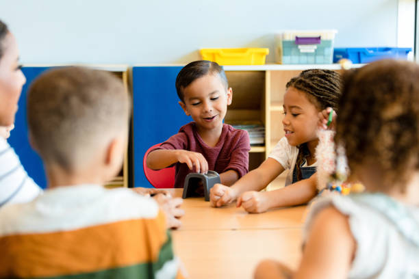 istock Preschool Children Playing Together in Classroom 2194423058