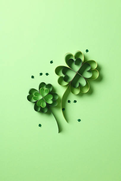 istock St Patrick's Day flat lay composition. Saint Patricks Day green background with paper cut four leaf clover 2194425178