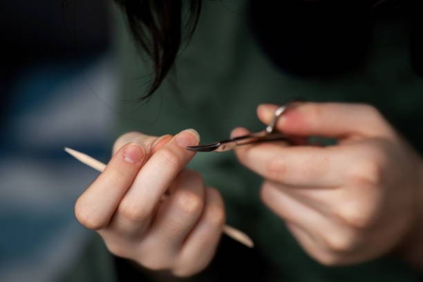 istock woman's fingers using small scissors to trim cuticles, showcasing a nail care routine for beauty and elegance 2194425668