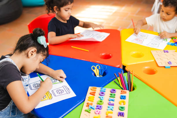 istock Preschool children learning about recycling and alphabet in kindergarten 2194427643