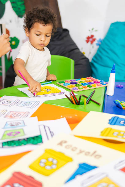 istock Little boy learning recycling activities in kindergarten 2194428413