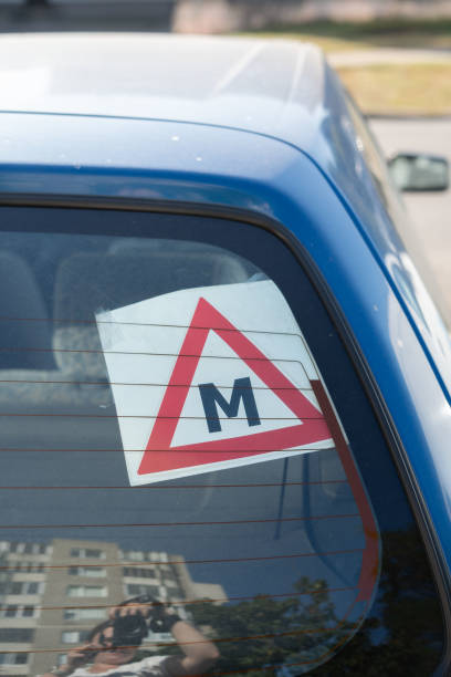 istock photo, symbol, driver, triangle, letter, automobile, learner, m, reflection, photography, image, blue, car, sign, displaying, vehicle, red, window 2194430803