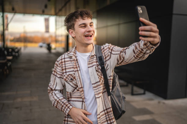 istock young man have video call on mobile phone while walk on the street 2194431186
