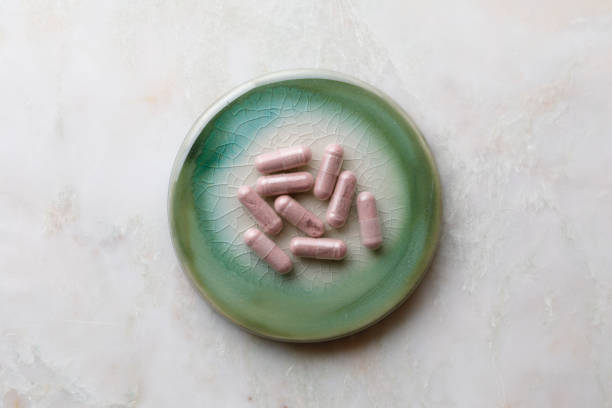 Whole food multivitamin vegetarian capsule on green cracked ceramic plate