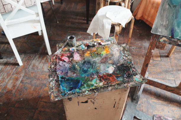 A Vibrant Artist Palette Filled with Various Paints in a Creative Art Studio Environment