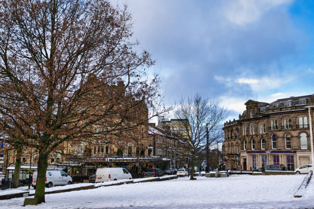 istock Snow-Covered Town Square with Victorian Buildings and Parked Vehicles in Harrogate, UK. 2194441268