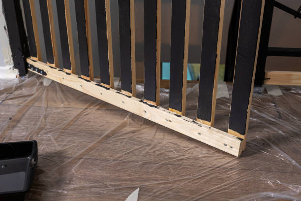 istock Partially Painted Wooden Railing with Black Vertical Slats Indoors 2194441645